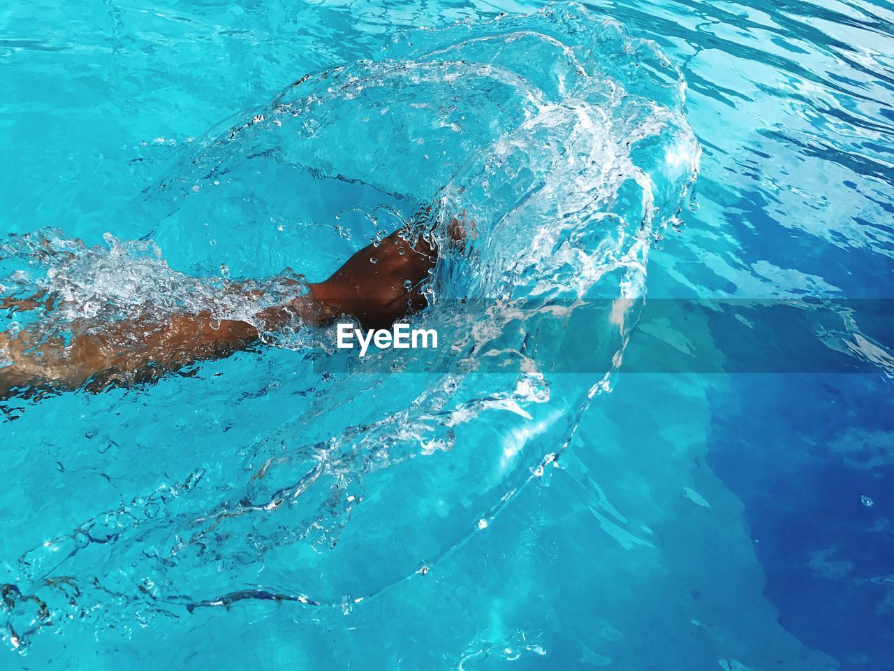 Hand splashing swimming in pool