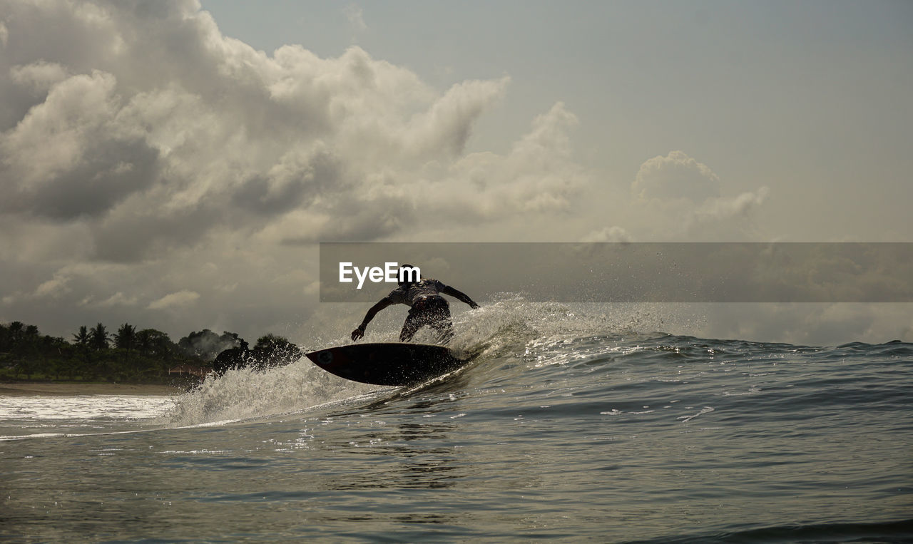 MAN SPLASHING WATER IN SEA