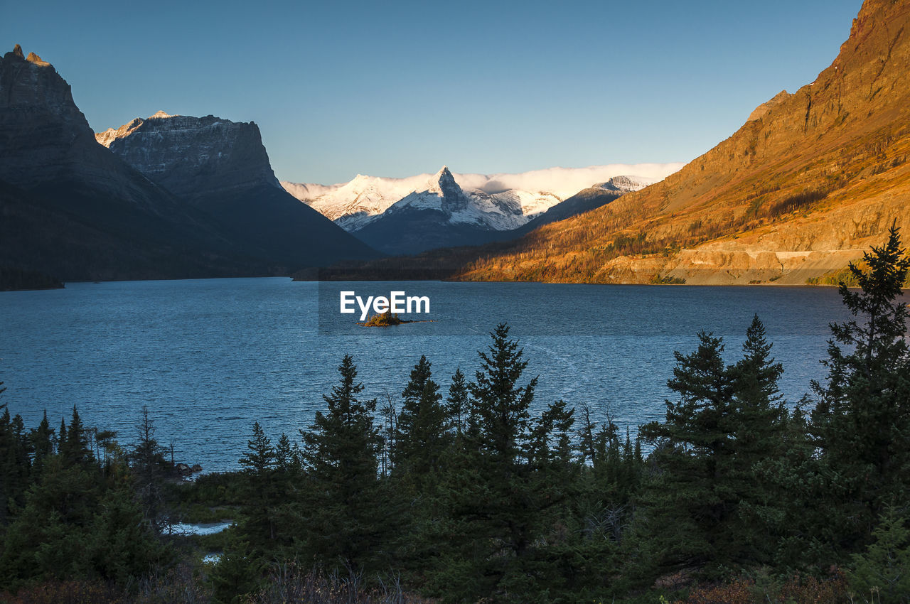 Scenic view of lake and mountains against sky