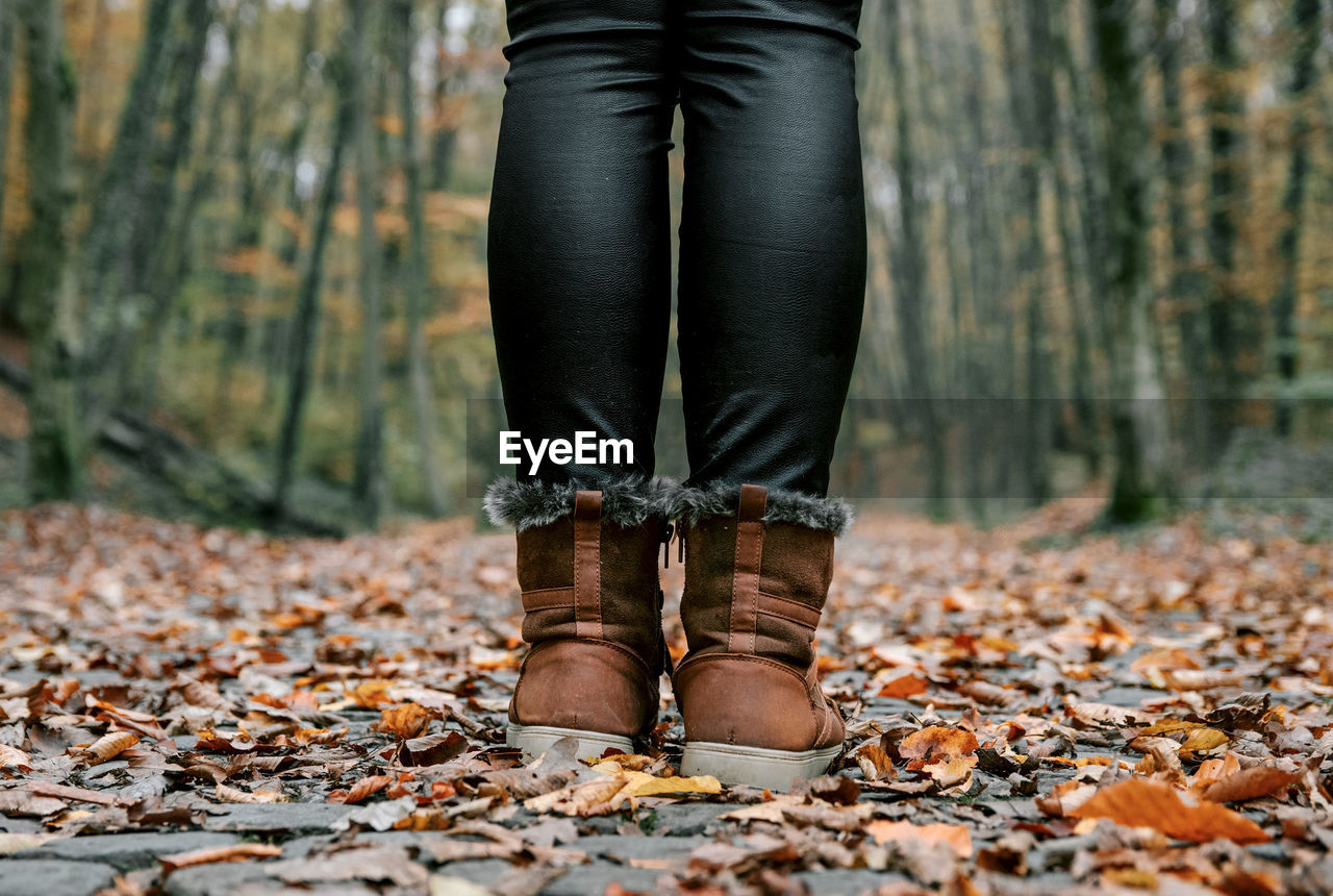 LOW SECTION OF WOMAN STANDING ON GROUND