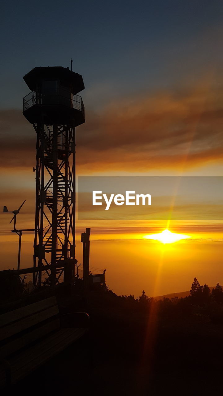 WATER TOWER AGAINST SKY AT SUNSET