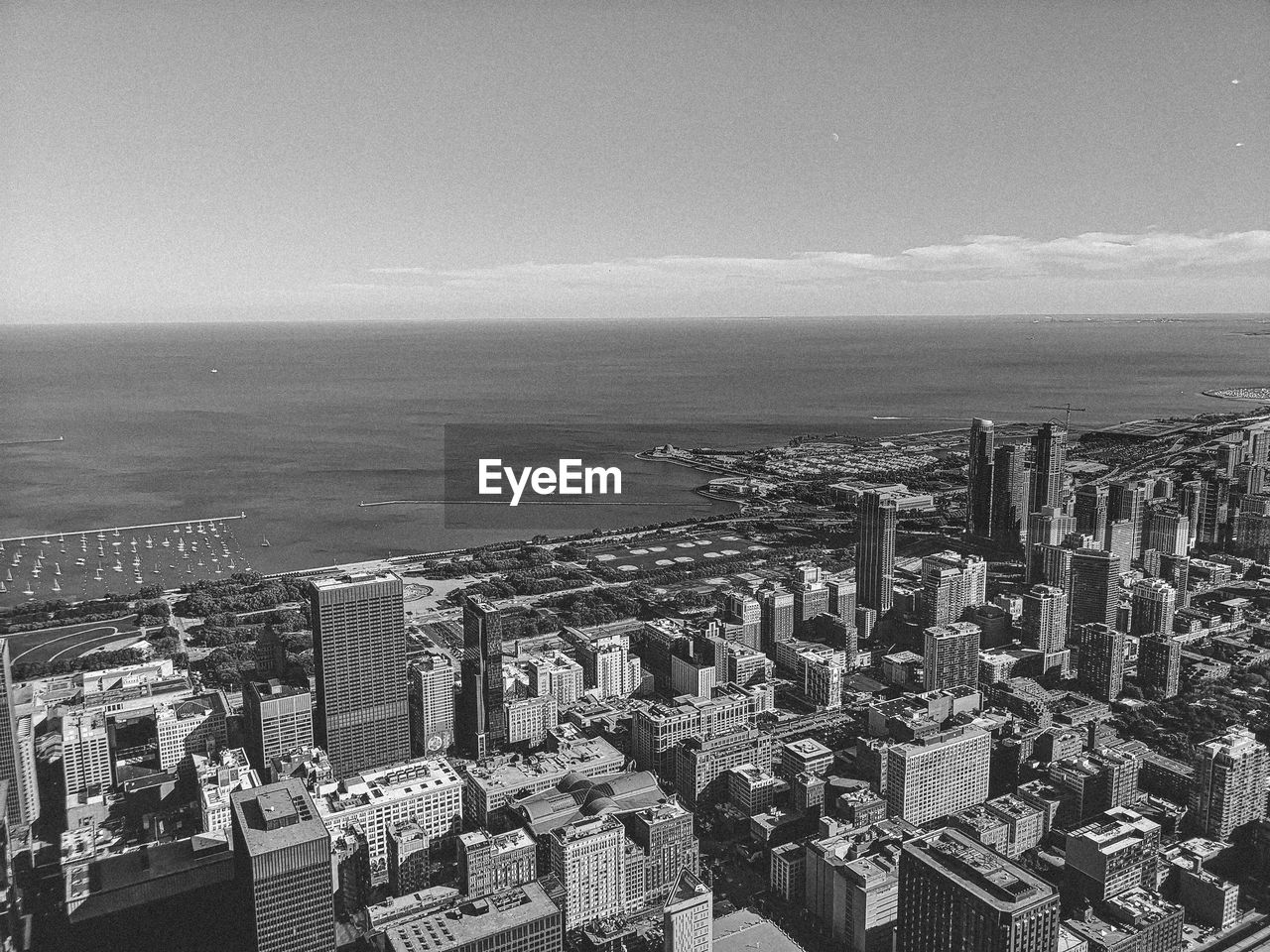 High angle view of buildings by sea against sky