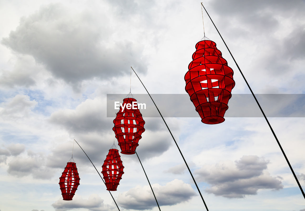 LOW ANGLE VIEW OF HEART SHAPE LANTERNS HANGING AGAINST SKY