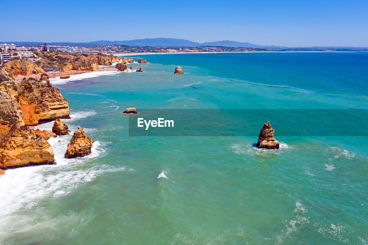 SCENIC VIEW OF SEA AGAINST ROCKS