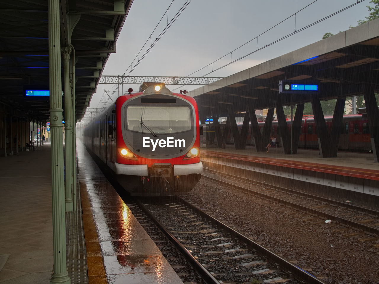 Train at railroad station platform during rainy season