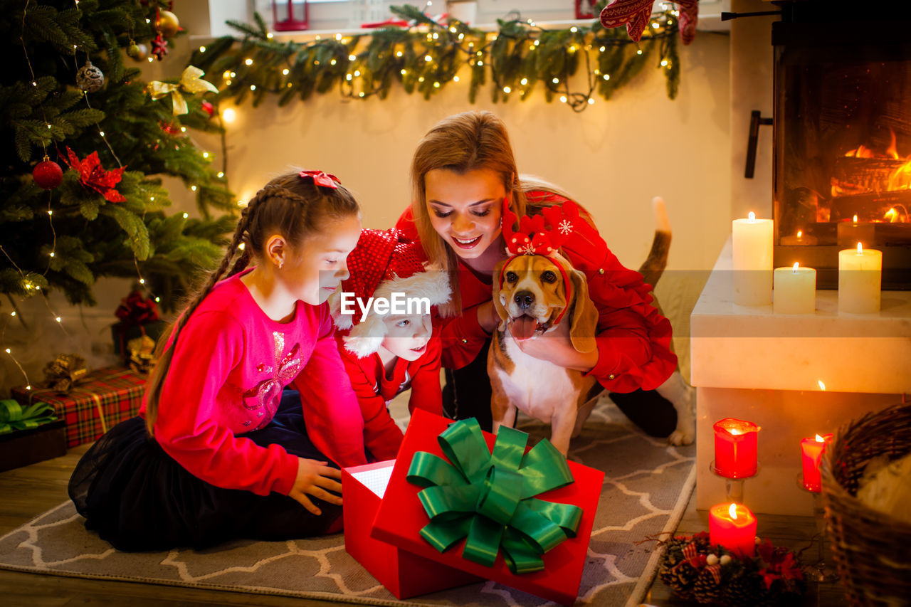 portrait of woman with christmas tree at home