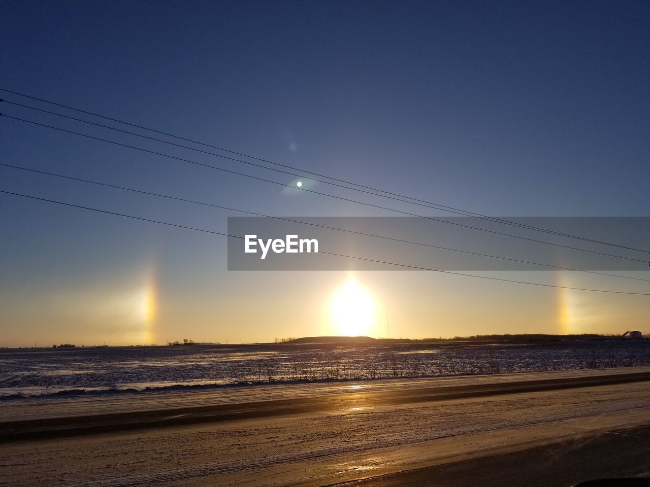 SCENIC VIEW OF LANDSCAPE AGAINST CLEAR SKY AT SUNSET