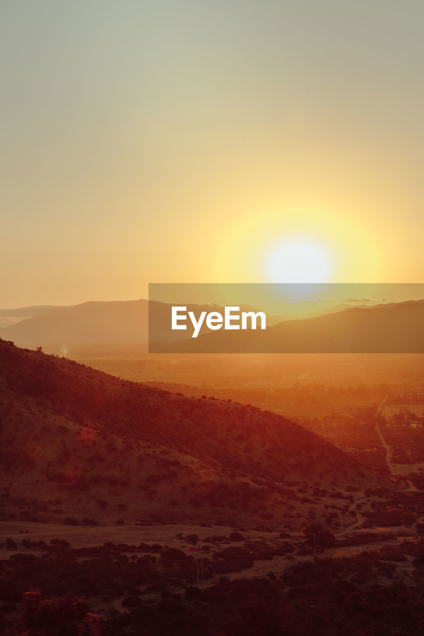 Scenic view of silhouette landscape against clear sky during sunset