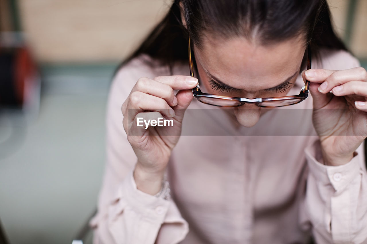 Close-up of businesswoman wearing eyeglasses while sitting at office