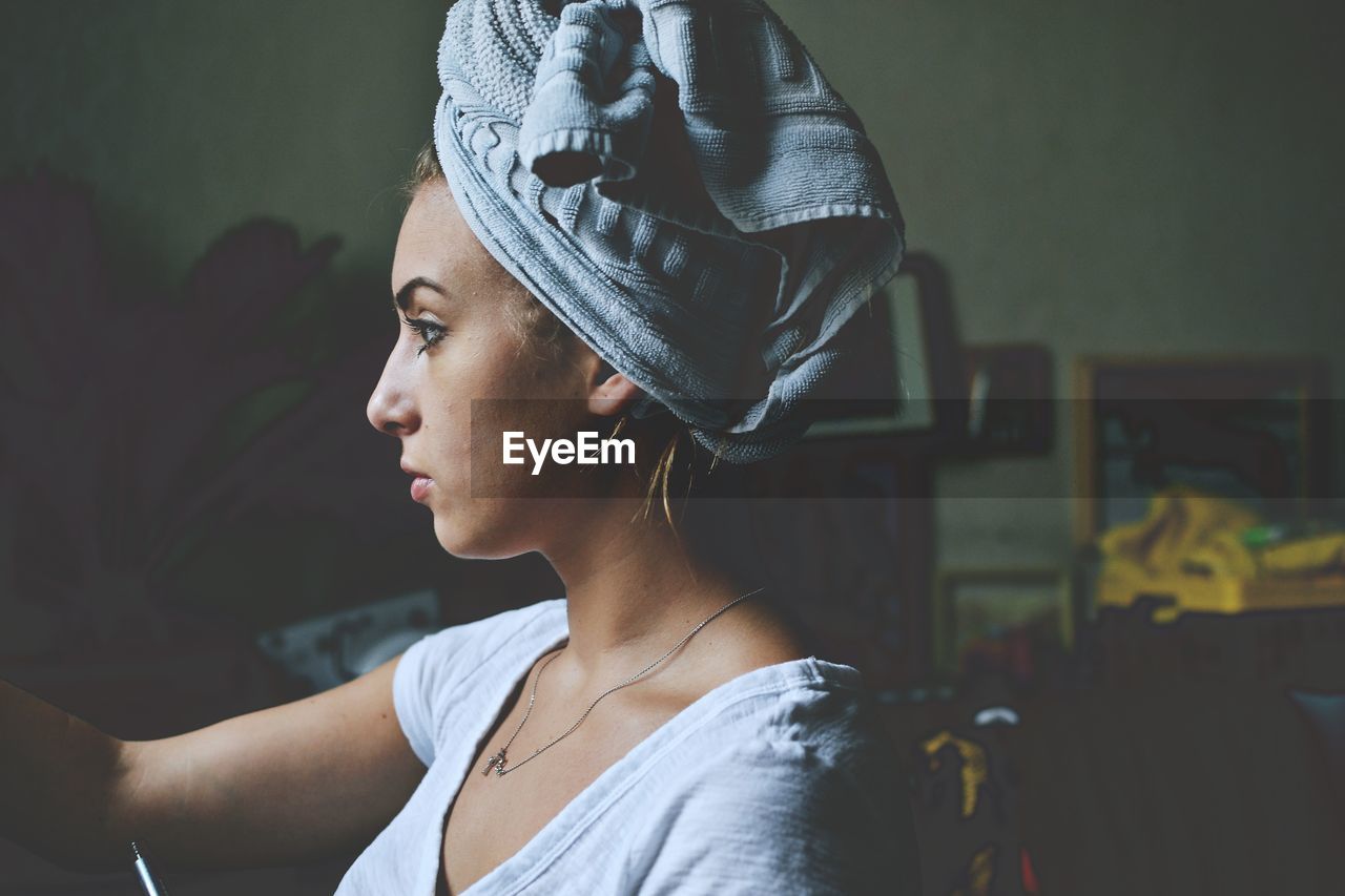 Close-up of woman with towel around her head