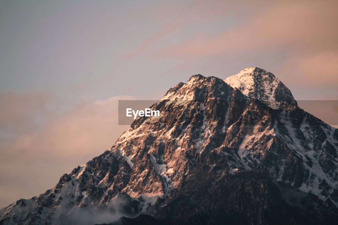 Scenic view of snowcapped mountains against sky during sunset