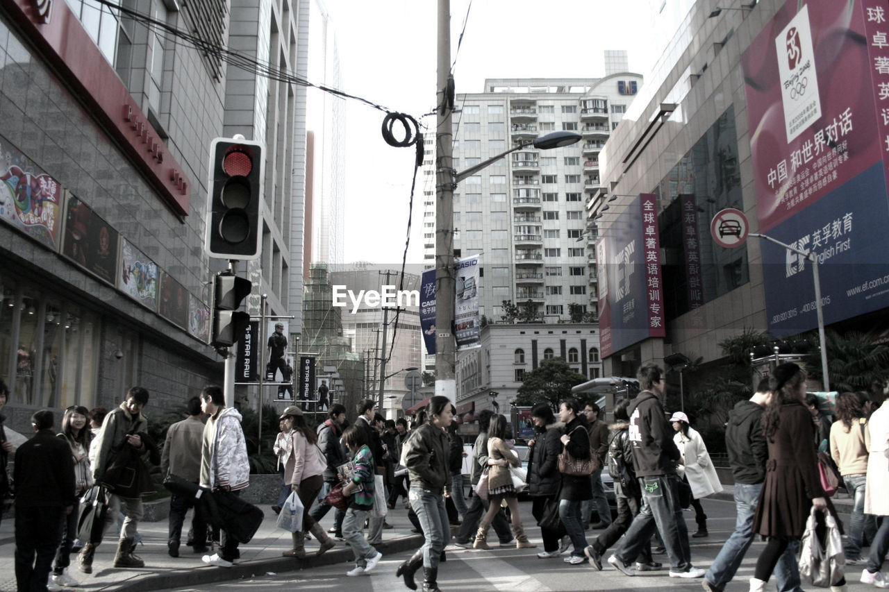 GROUP OF PEOPLE WALKING ON CITY STREET IN OFFICE BUILDINGS