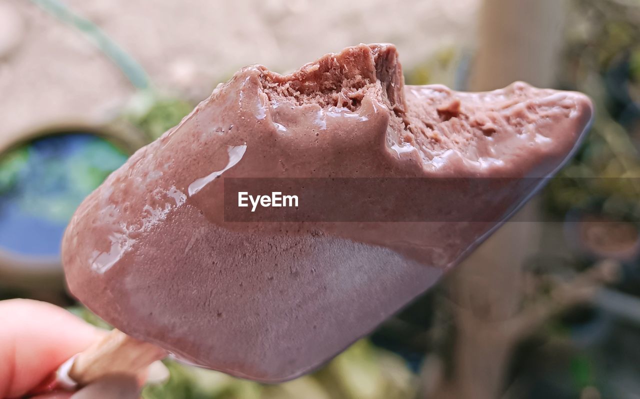 Close-up of hand holding ice cream