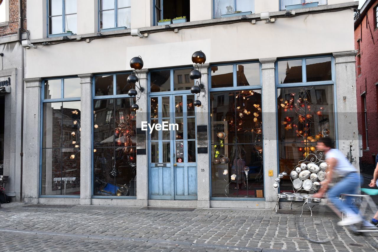 Cyclist passing beautiful shop window 