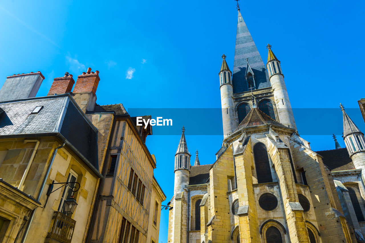 Low angle view of buildings in town against sky