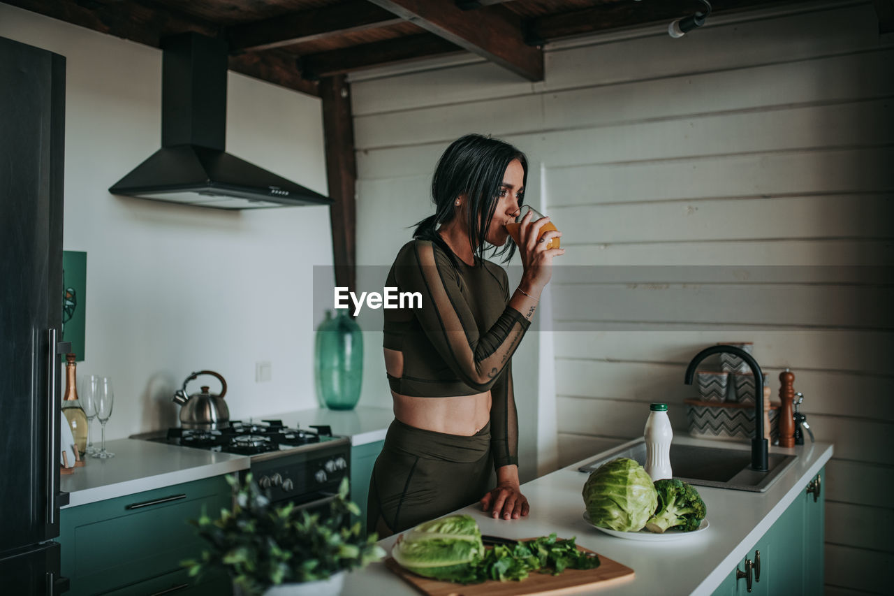 Midsection of woman standing at home