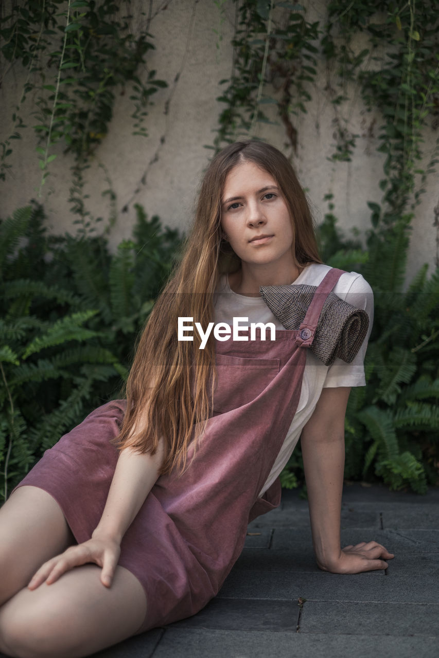 Portrait of young woman sitting outdoors