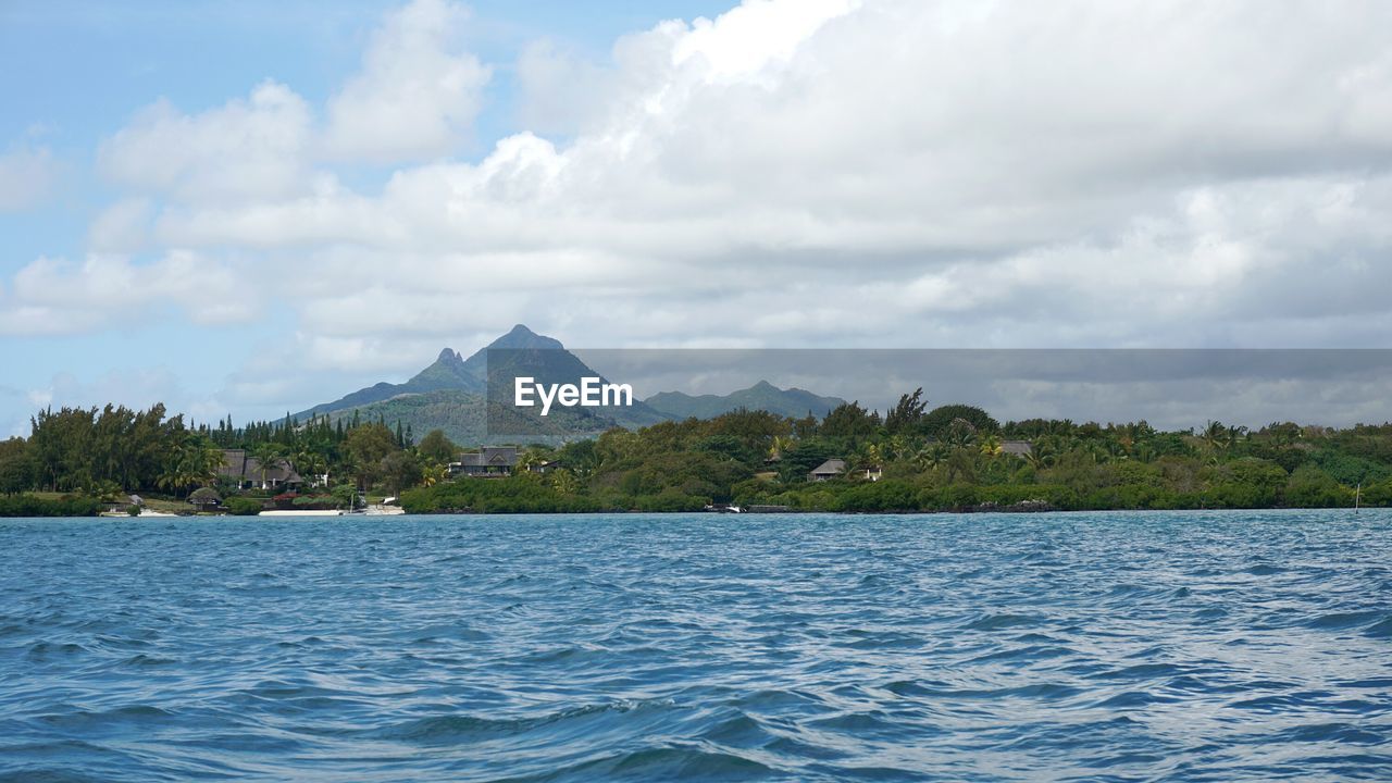 Scenic view of lake and mountains against sky