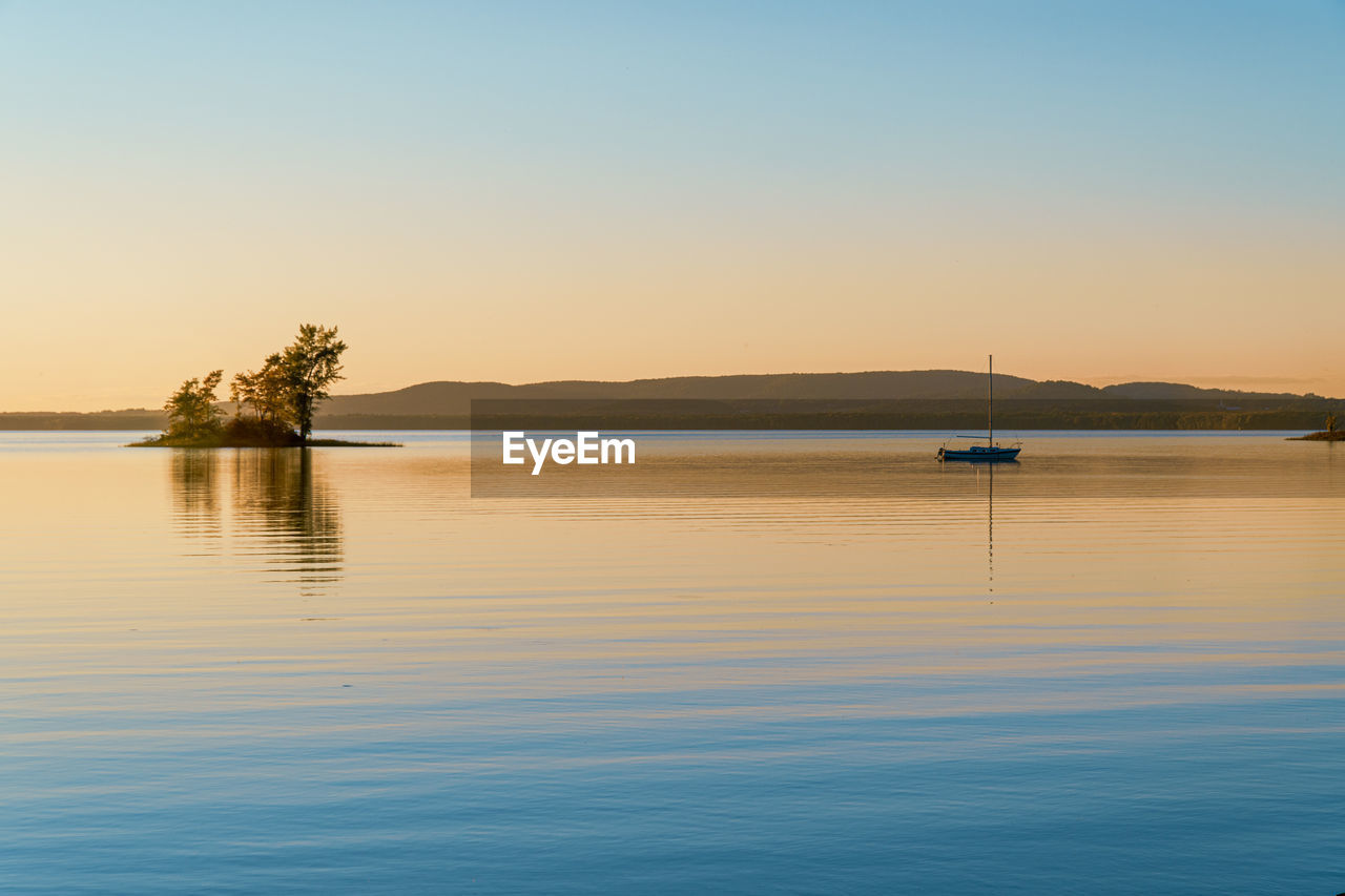 Scenic view of lake against sky during sunset