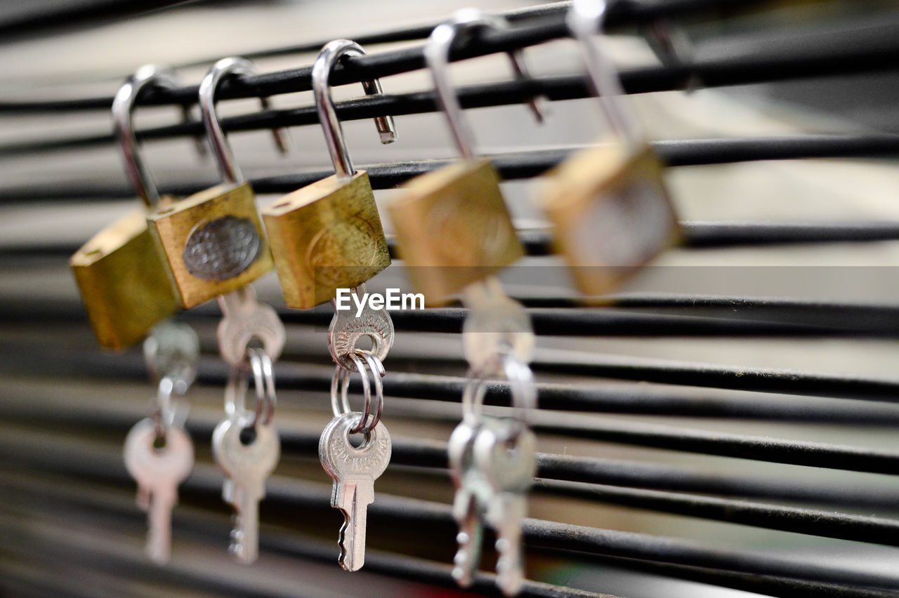 Series of padlocks hanging on cables