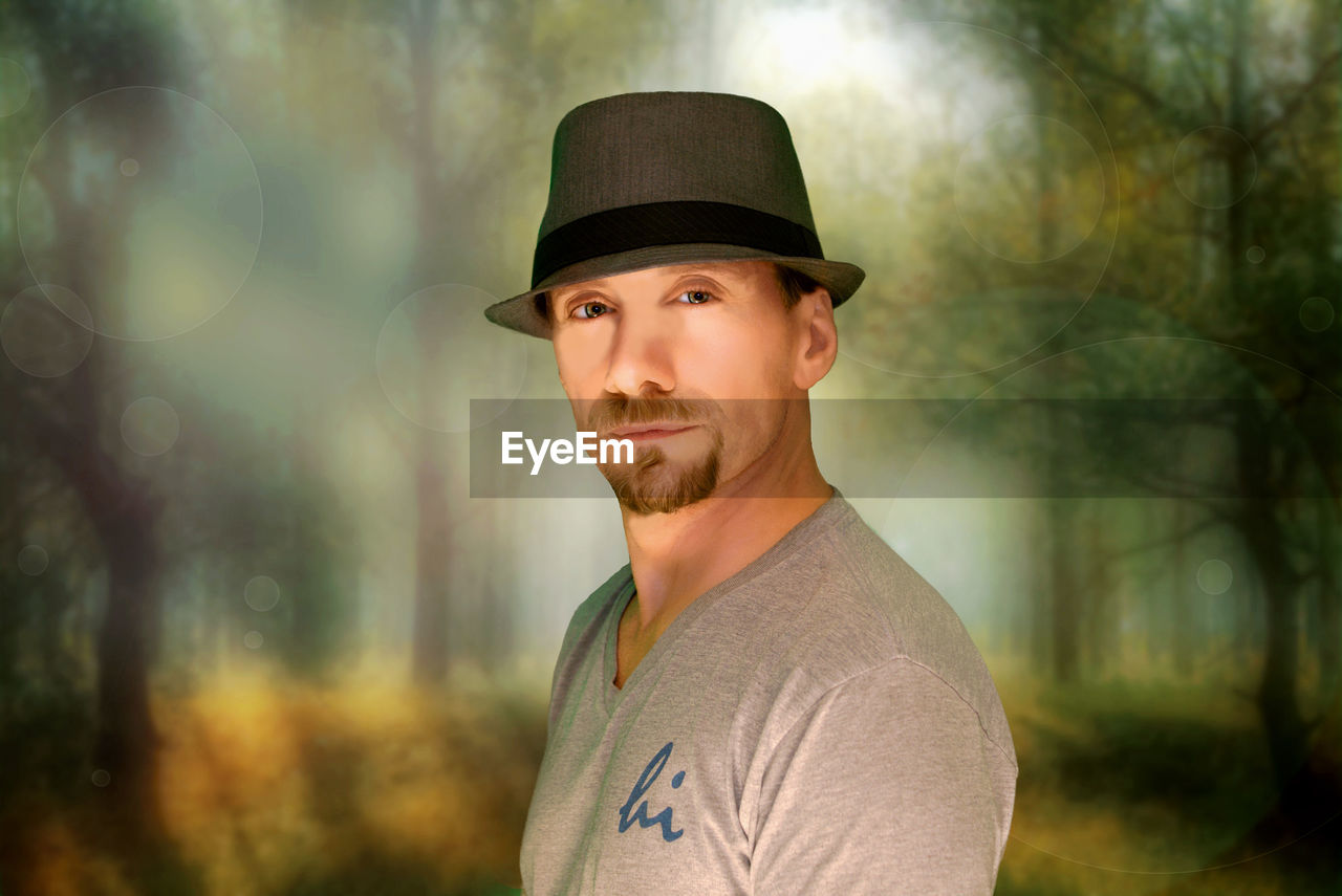 PORTRAIT OF YOUNG MAN WEARING HAT