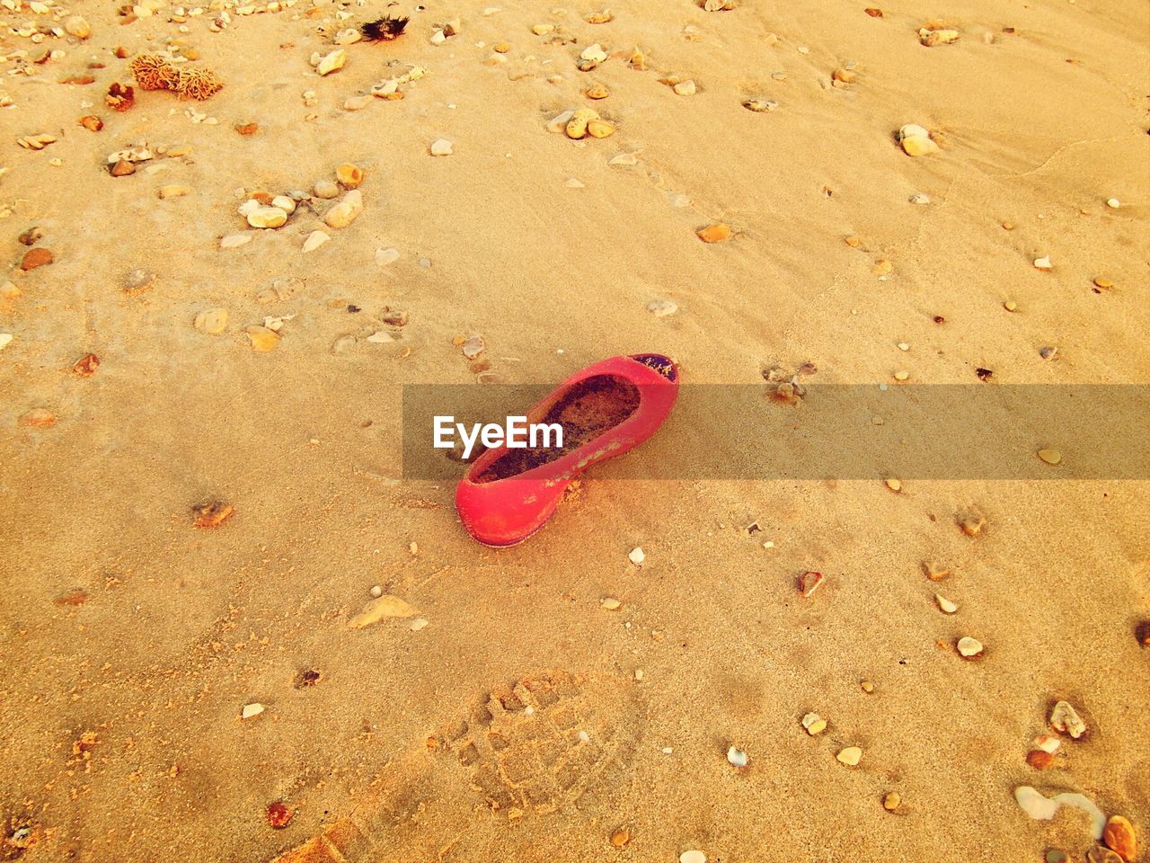 High angle view of female footwear on sand at beach