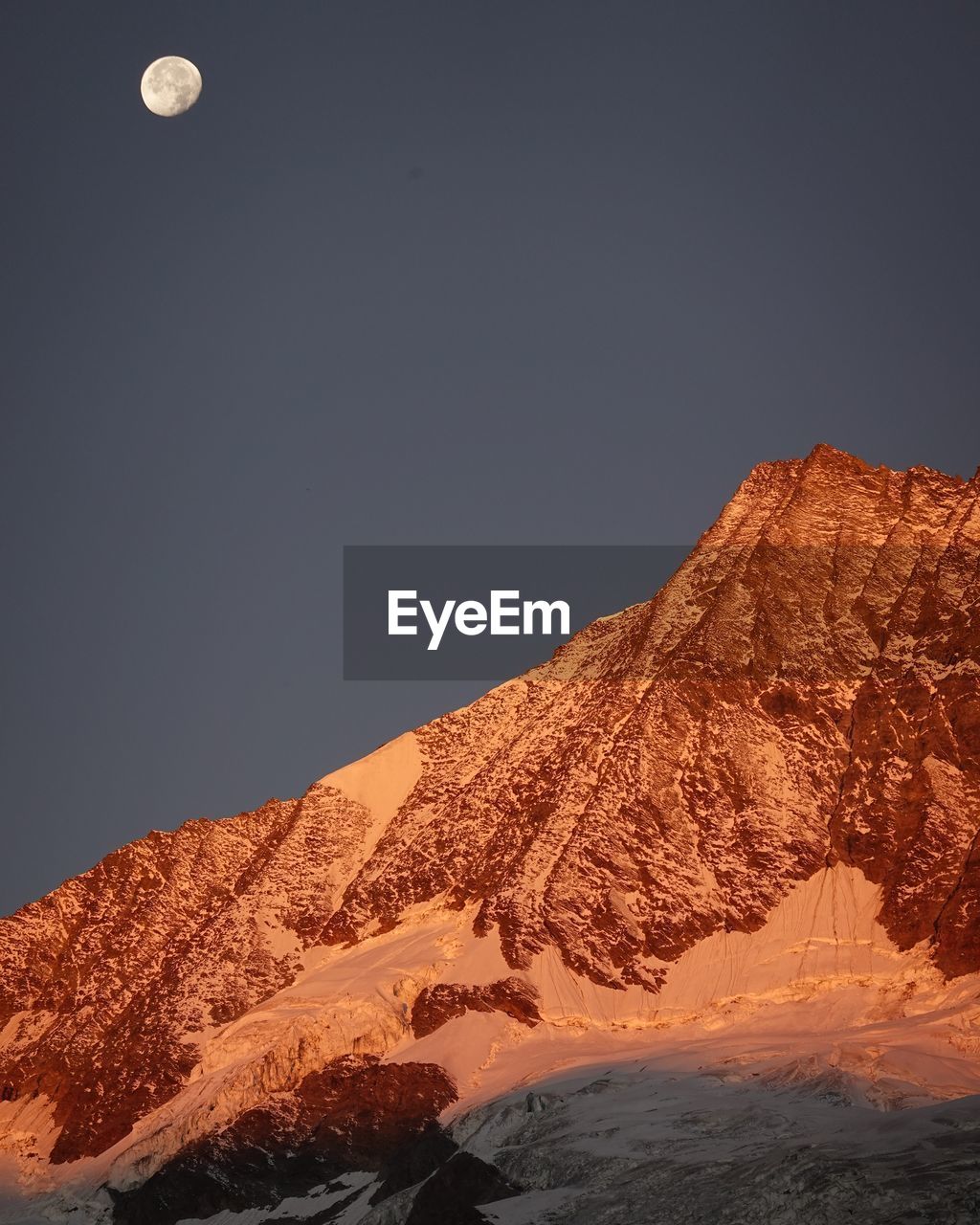 LOW ANGLE VIEW OF SNOWCAPPED MOUNTAIN AGAINST SKY DURING WINTER