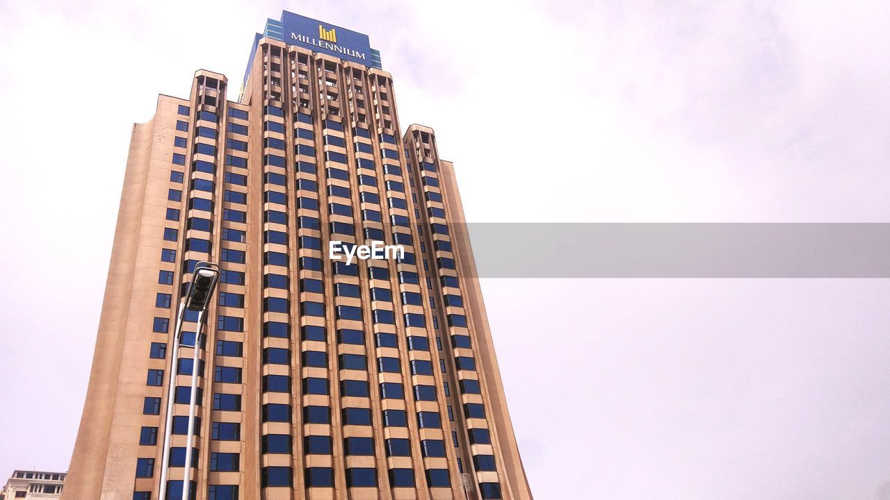 LOW ANGLE VIEW OF OFFICE BUILDING AGAINST SKY