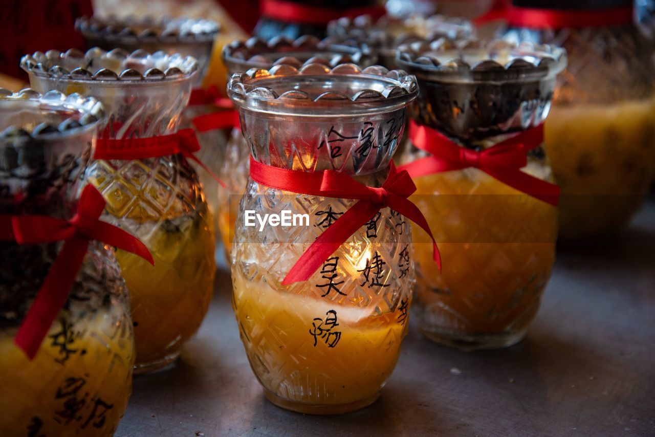 CLOSE-UP OF GLASSES OF JAR ON TABLE