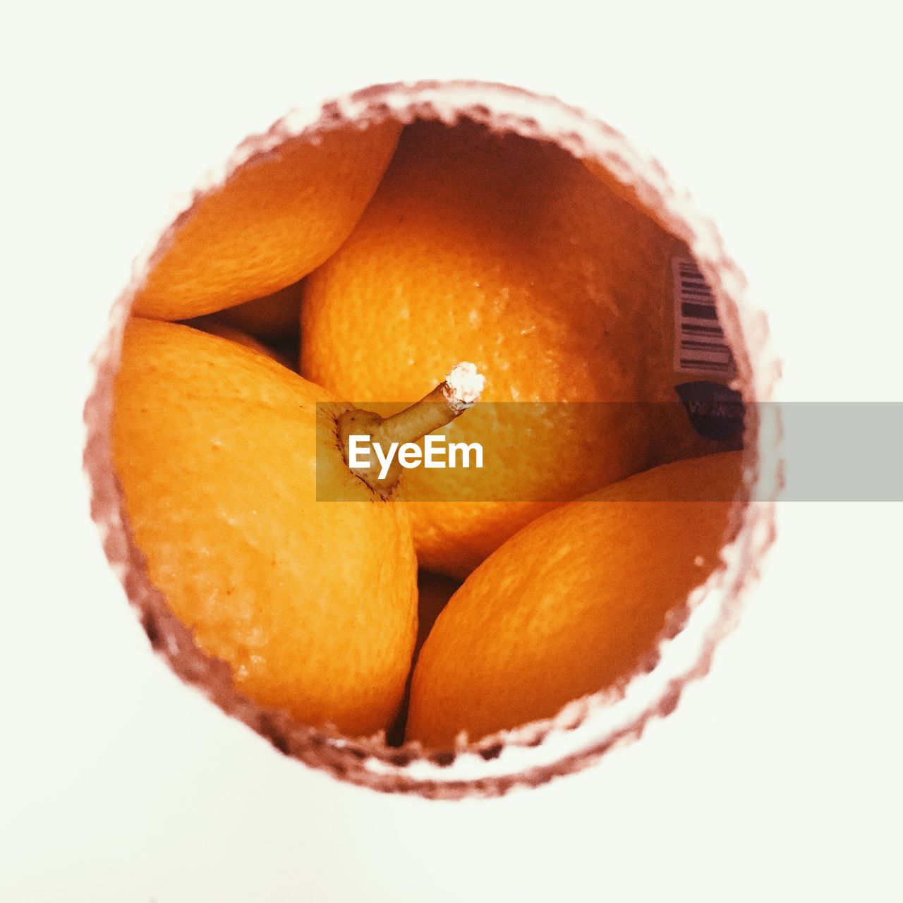 Oranges seen through hole indoors