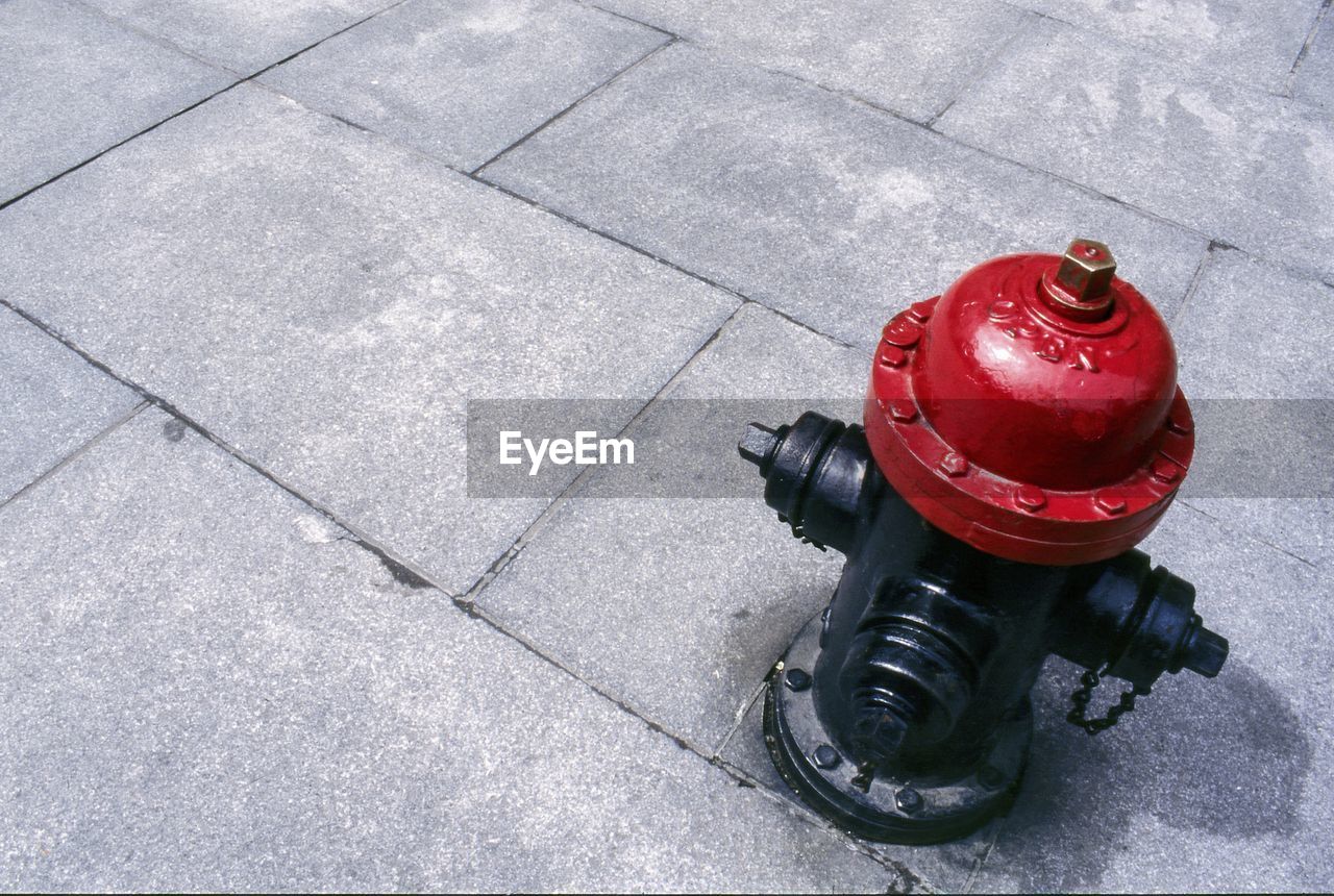 High angle view of fire hydrant on footpath