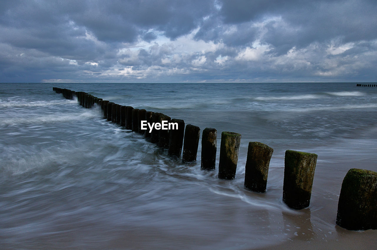 WOODEN POSTS IN SEA