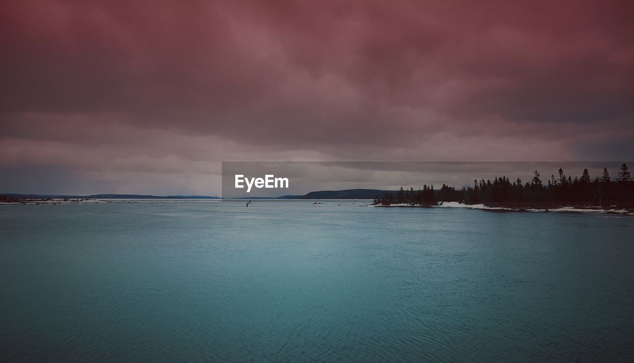 PANORAMIC VIEW OF SEA AGAINST DRAMATIC SKY