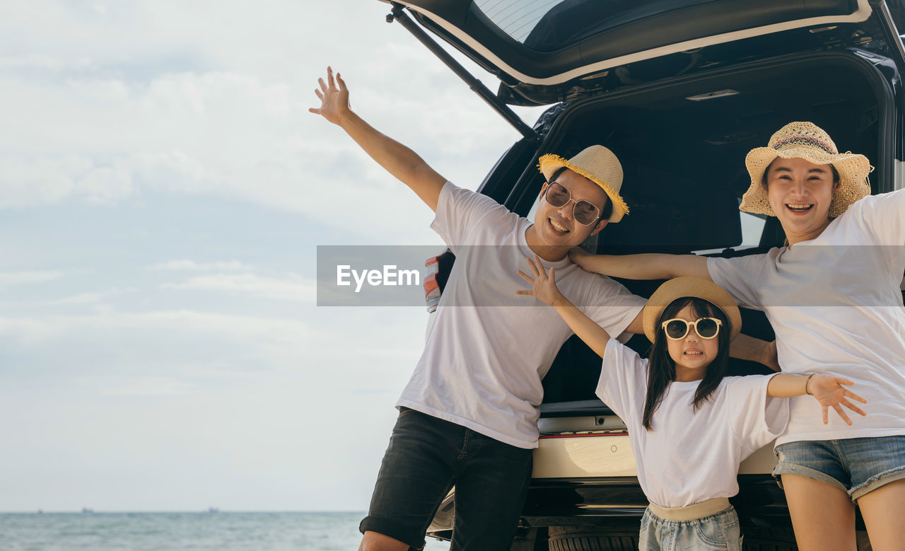 rear view of couple standing at beach