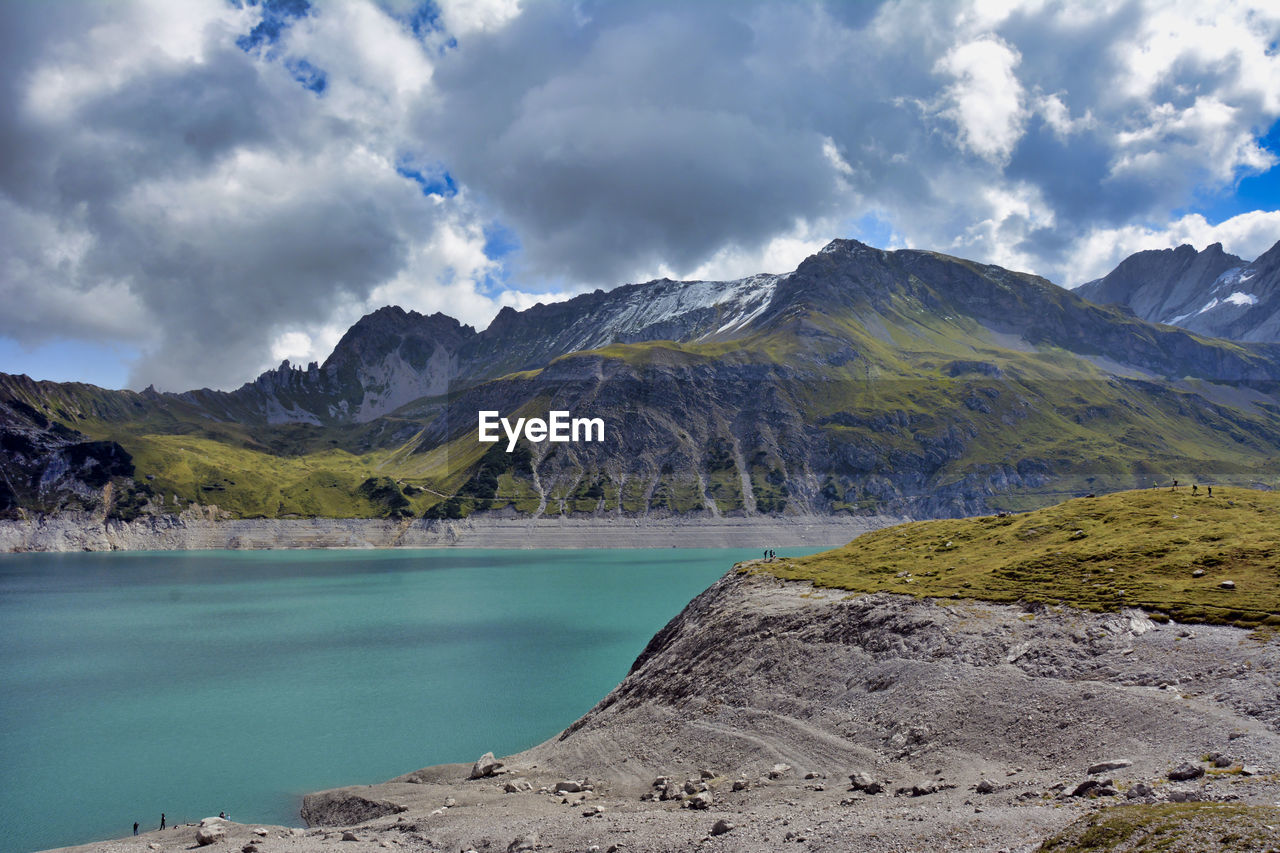 Scenic view of lake and mountains against sky