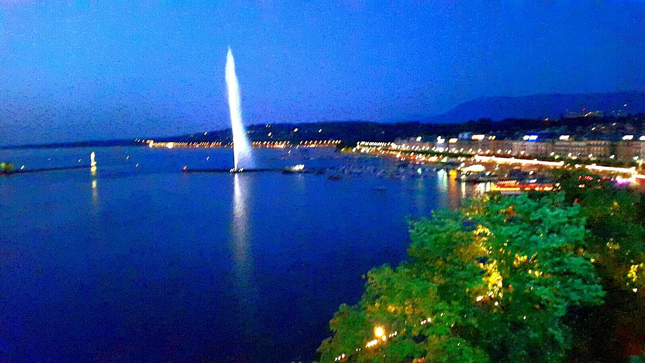 VIEW OF ILLUMINATED CITYSCAPE AT NIGHT