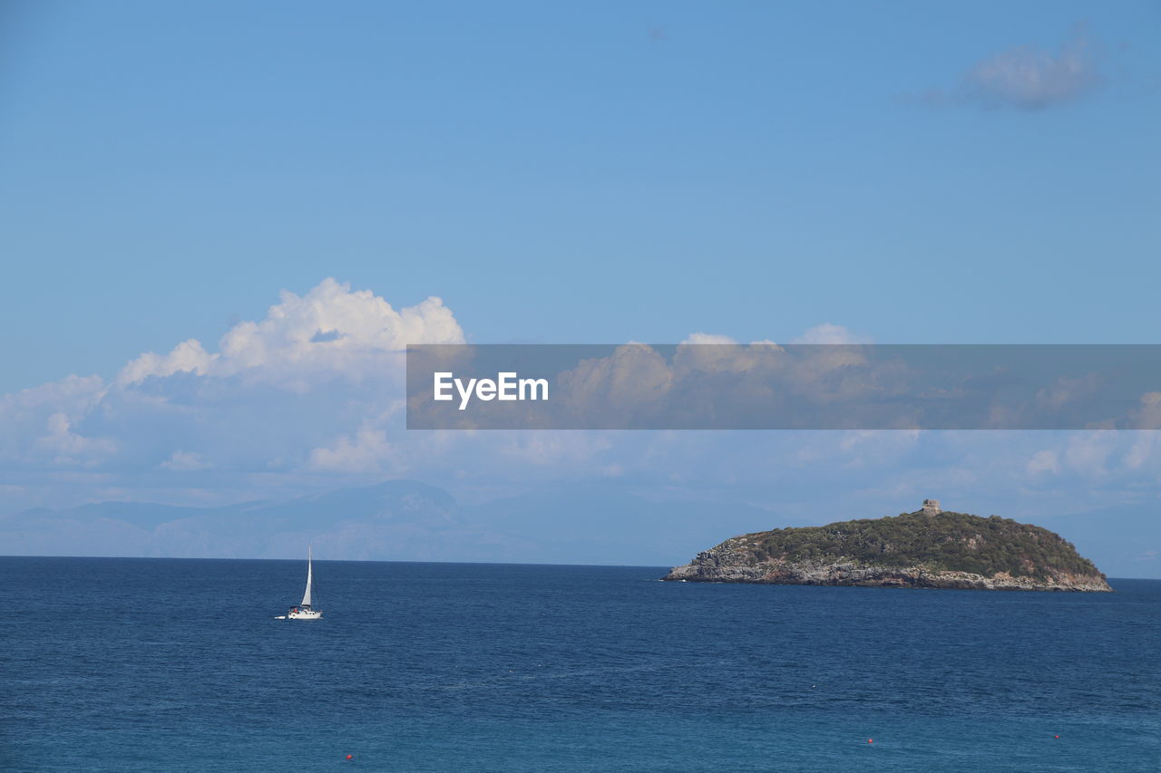 sea, water, horizon, sky, ocean, scenics - nature, beauty in nature, nautical vessel, cloud, nature, transportation, blue, sailboat, body of water, coast, shore, travel, tranquility, horizon over water, no people, tranquil scene, land, sailing, mode of transportation, ship, day, vehicle, islet, outdoors, bay, travel destinations, island, idyllic, beach, environment, holiday, seascape, sailing ship, vacation, trip, rock