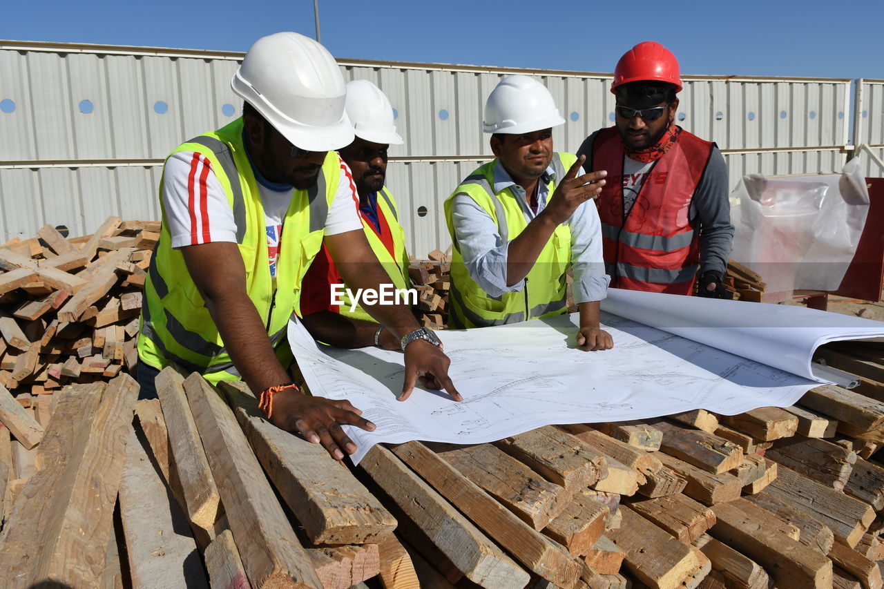 Engineers working over blueprint