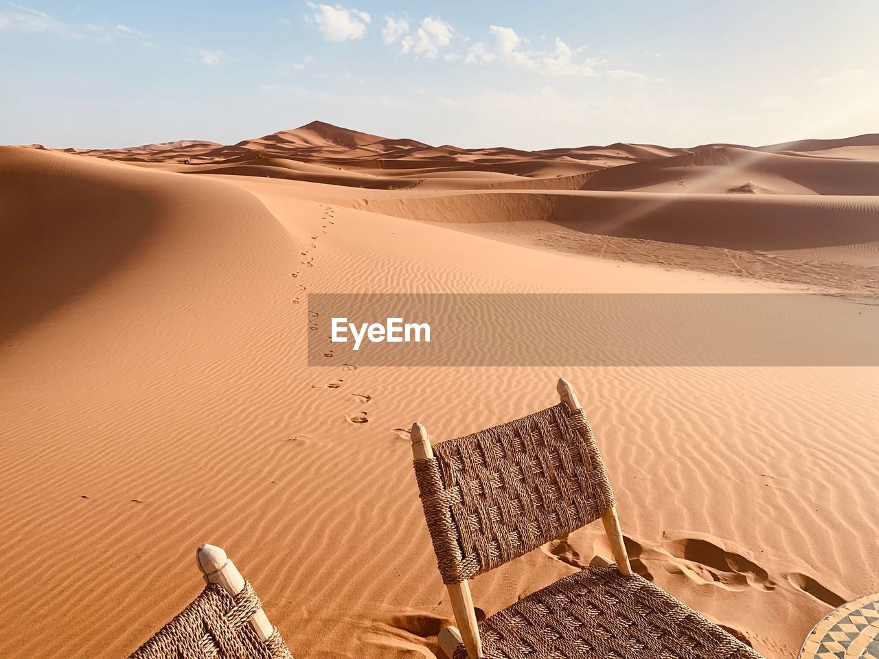 Sand dunes in desert against sky