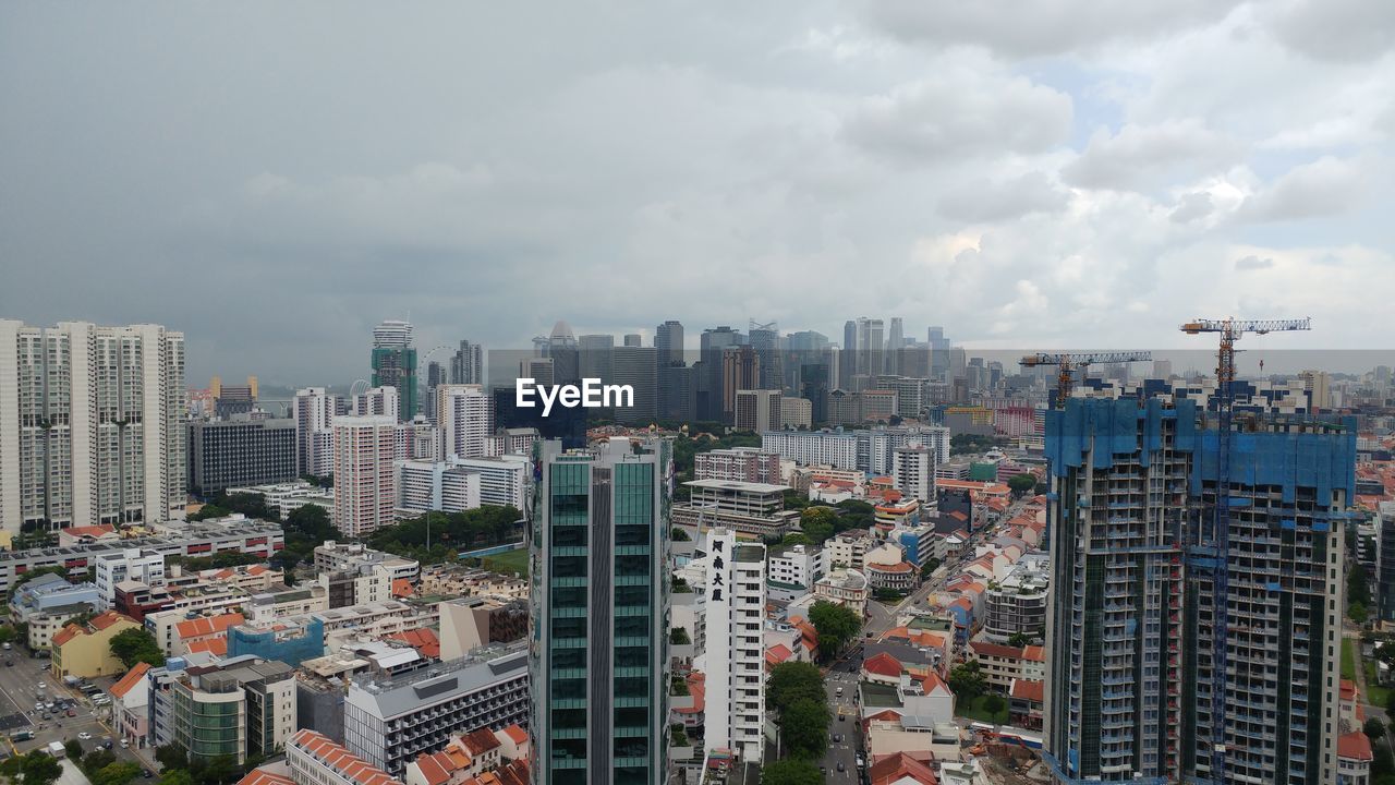 HIGH ANGLE VIEW OF MODERN BUILDINGS AGAINST SKY