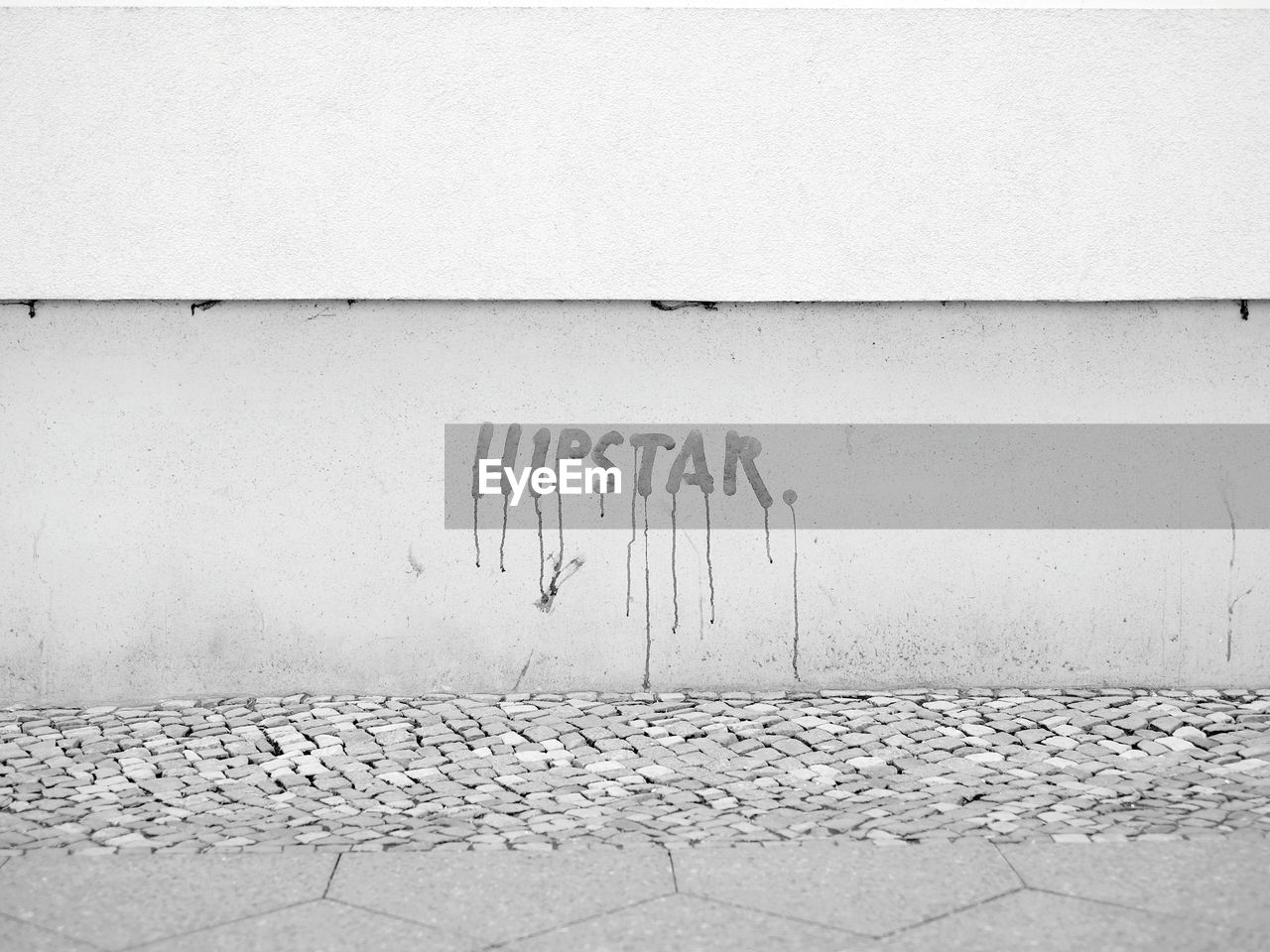 Graffiti on retaining wall against clear sky