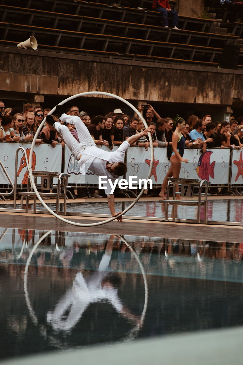 PEOPLE IN SWIMMING POOL WITH REFLECTION