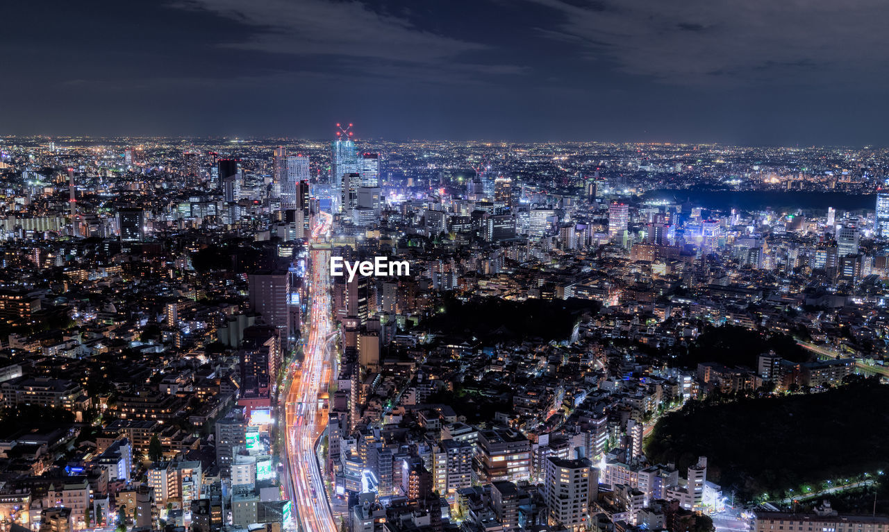 HIGH ANGLE VIEW OF ILLUMINATED BUILDINGS IN CITY