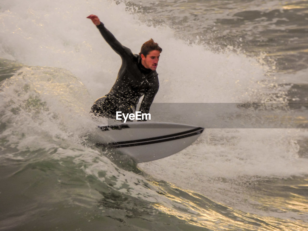 MAN SURFING ON SEA