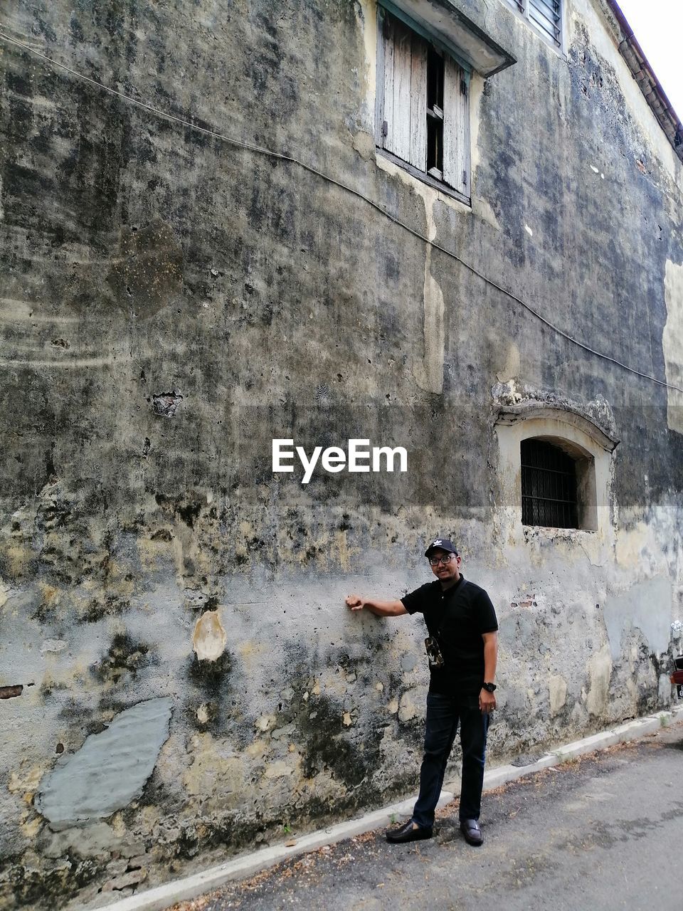 Full length of man standing by building in city