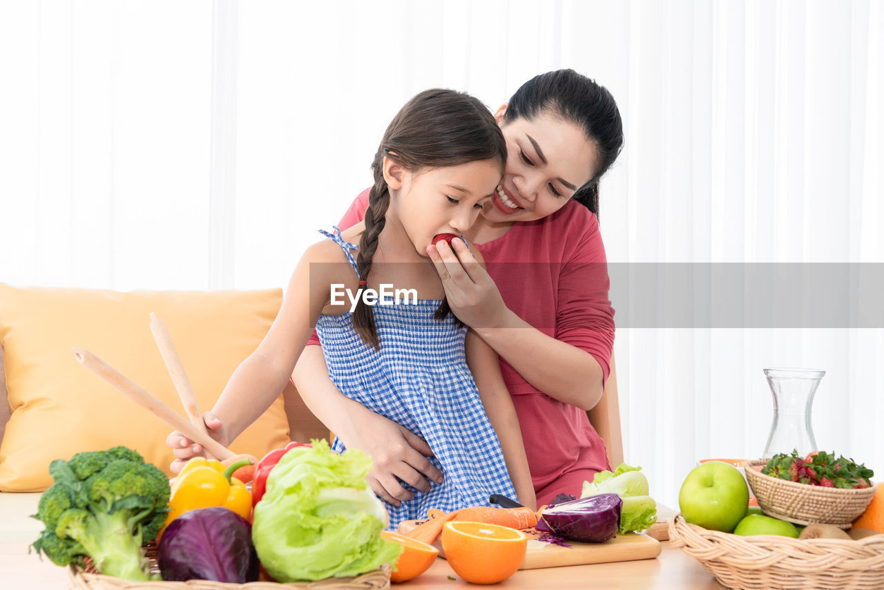 YOUNG WOMAN WITH FRUITS