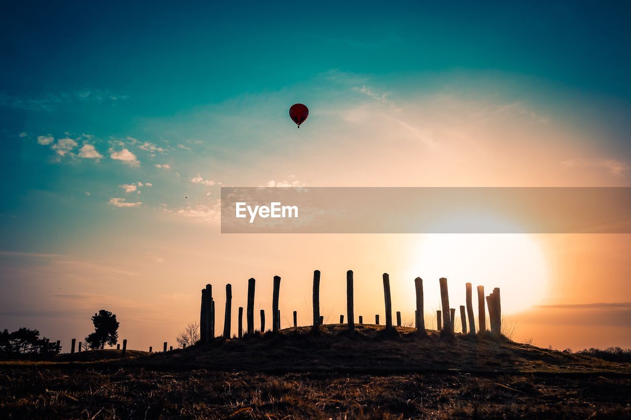 Low angle view of silhouette hot air balloon against sky during sunset