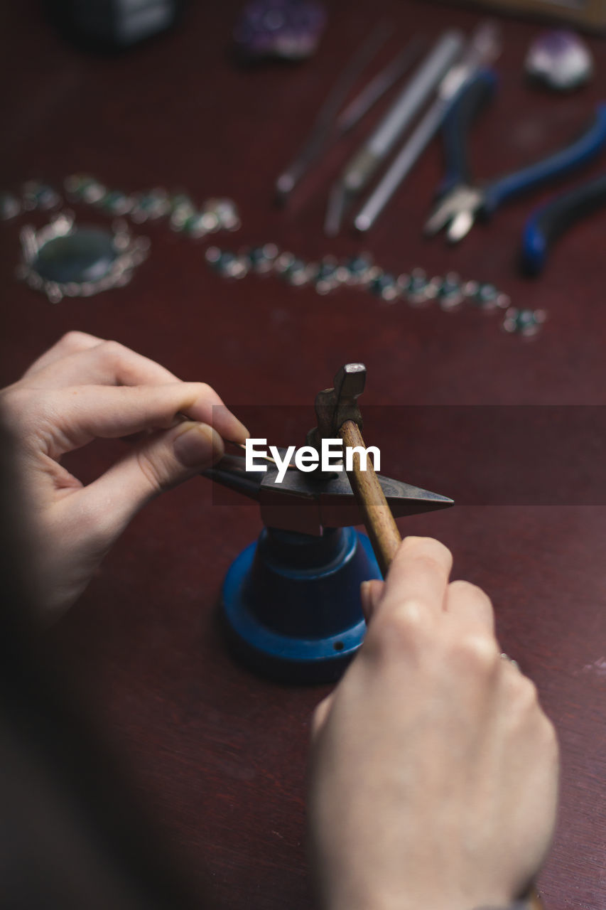 Close up jewelry hammer and tiny anvil concept photo