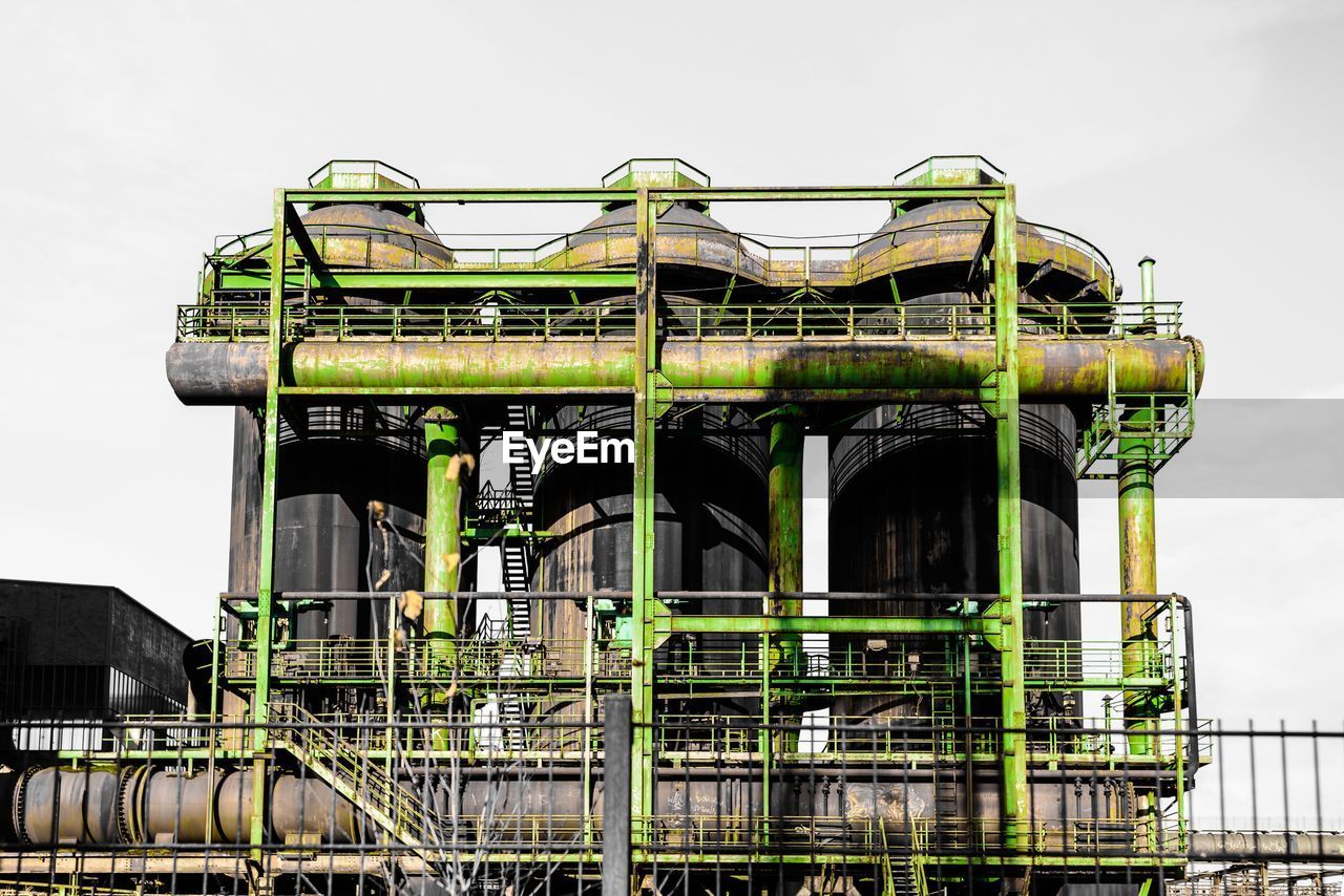 Low angle view of industry against clear sky
