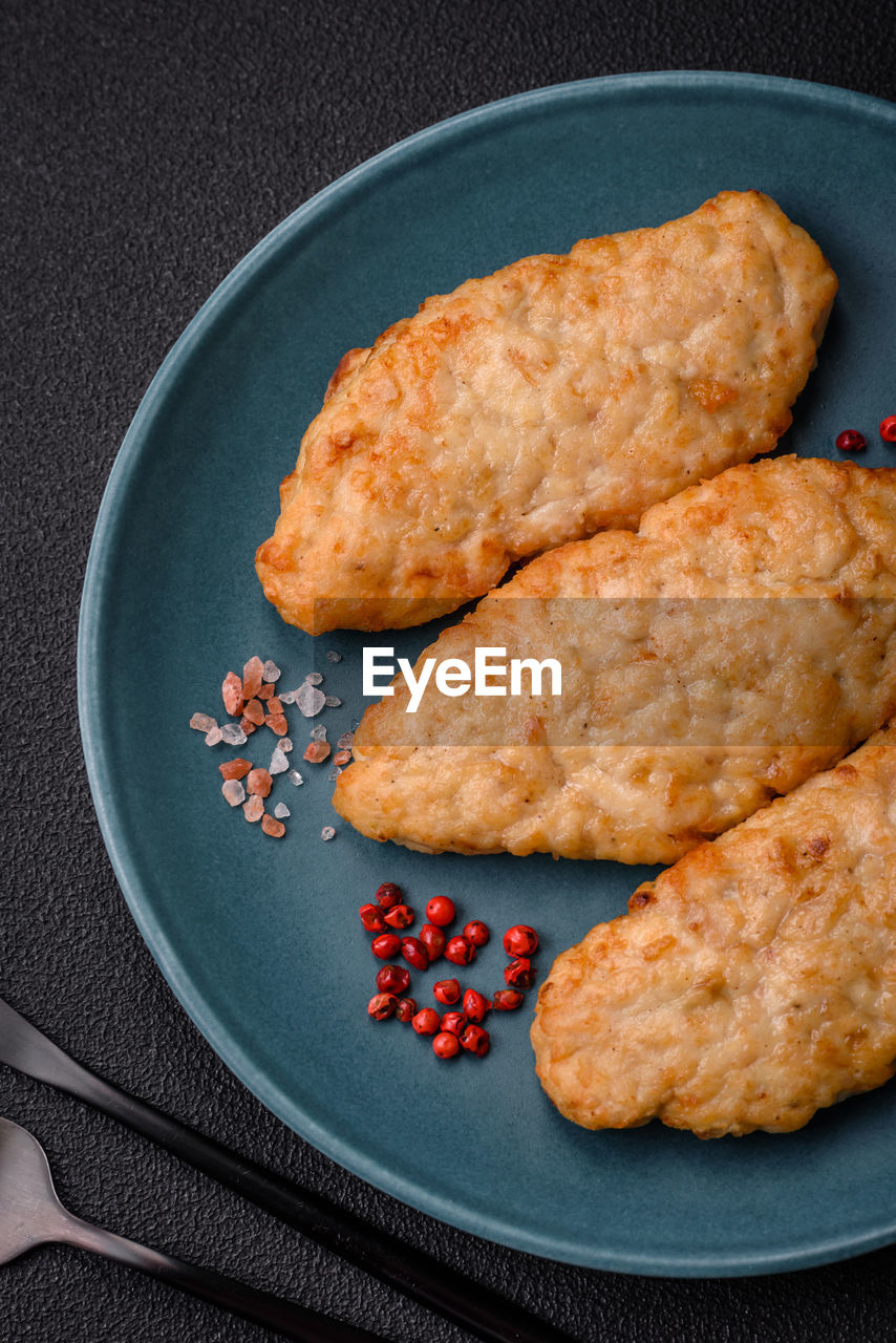 food and drink, food, studio shot, dish, produce, fried food, no people, baked, freshness, indoors, plate, fried, snack, breakfast, fast food, high angle view, healthy eating, meal, sweet food, black background, dessert, fish, still life